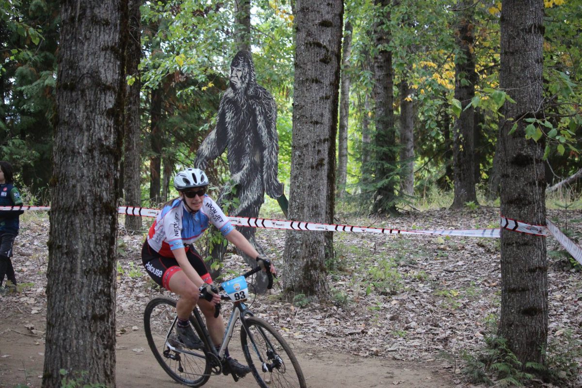 2017 Crosstober Fest - Adult bicycle racer on course with Sasquatch in the background
