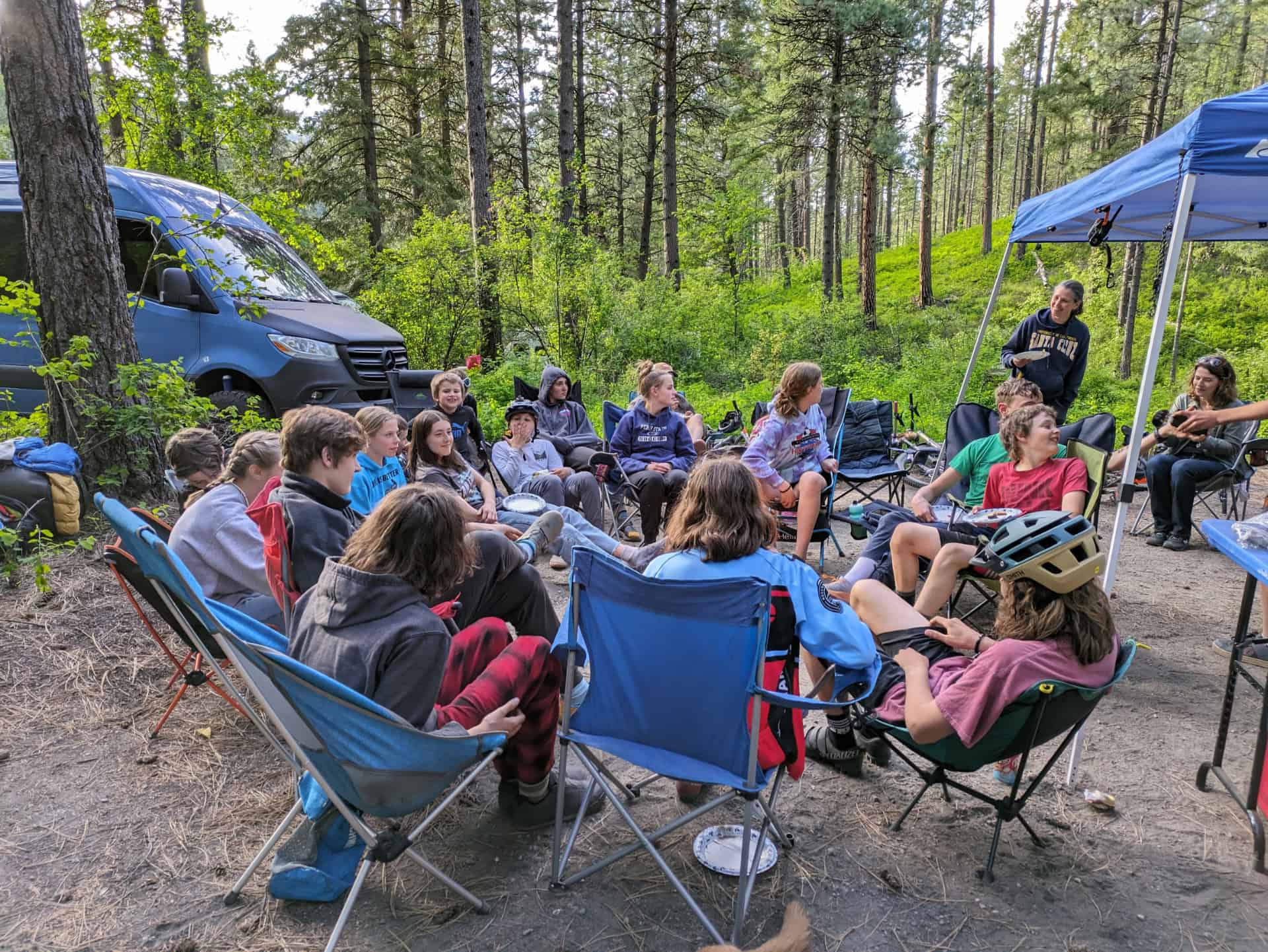 PBR members around campfire socializing and having dinner.